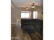 Spacious living room with wood-look tile flooring and comfortable, over-sized, sectional sofa at 13486 W Evans Dr, Surprise, AZ 85379
