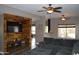 Inviting living room featuring a rustic wood accent wall, TV, and comfortable seating at 13486 W Evans Dr, Surprise, AZ 85379