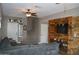 Comfortable living room with a gray sectional sofa and rustic wood accent wall and staircase at 13486 W Evans Dr, Surprise, AZ 85379