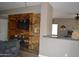 Cozy living room featuring an entertainment center and wood flooring at 13486 W Evans Dr, Surprise, AZ 85379