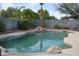 Inviting backyard pool with rock waterfall feature and lush landscaping at 13486 W Evans Dr, Surprise, AZ 85379