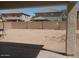 View of a sand back yard surrounded by a brick fence at 14150 W Boca Raton Rd, Surprise, AZ 85379
