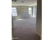 Bedroom with two windows and neutral carpeting, offering a bright and cozy living space at 14150 W Boca Raton Rd, Surprise, AZ 85379
