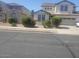 View of a charming two-story home with a well-manicured lawn and an attached two-car garage at 14150 W Boca Raton Rd, Surprise, AZ 85379
