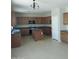 Spacious kitchen with wooden cabinets, stainless steel appliances, and a center island at 14150 W Boca Raton Rd, Surprise, AZ 85379