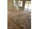 Spacious living room with large area rug and sliding glass doors to outdoor space at 14150 W Boca Raton Rd, Surprise, AZ 85379