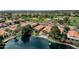 Aerial view of stunning lakefront homes with pristine landscaping, offering picturesque views of the water and nearby community park at 1558 W Maplewood St, Chandler, AZ 85286