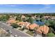 An aerial view of a lakeside community with landscaped yards and tile roofs, all under a clear blue sky at 1558 W Maplewood St, Chandler, AZ 85286