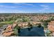 Aerial view of a neighborhood featuring a lake with fountains, mature trees, and manicured lawns at 1558 W Maplewood St, Chandler, AZ 85286