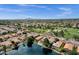 Beautiful neighborhood featuring houses around a lake, desert landscaping, mature trees, and a community park at 1558 W Maplewood St, Chandler, AZ 85286