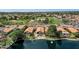 Lakefront homes featuring private pools and manicured lawns, offering stunning views of the lake and nearby green spaces at 1558 W Maplewood St, Chandler, AZ 85286