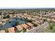 An aerial view showcasing a lakeside neighborhood with lush landscaping, manicured lawns, and red tile roofing at 1558 W Maplewood St, Chandler, AZ 85286