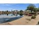 Stunning backyard with lake views, a cozy fireplace, and comfortable seating for relaxing and entertaining at 1558 W Maplewood St, Chandler, AZ 85286