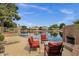 Tranquil lakeside backyard with a fireplace, comfortable seating, and stunning views of the surrounding neighborhood at 1558 W Maplewood St, Chandler, AZ 85286