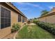 Spacious backyard featuring a well-manicured lawn, rock landscaping, and an outdoor dining set at 1558 W Maplewood St, Chandler, AZ 85286