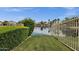 Scenic backyard view with a calm lake and lush landscaping for a serene outdoor living experience at 1558 W Maplewood St, Chandler, AZ 85286