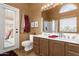 Primary bathroom has double sinks, vanity lighting, a private toilet and an attached shower at 1558 W Maplewood St, Chandler, AZ 85286