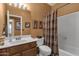 Cozy bathroom with a tub and shower, decorative shower curtain and ample counter space at 1558 W Maplewood St, Chandler, AZ 85286