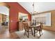 The charming dining area has warm colors, a rustic table, and classic chandelier, perfect for entertaining at 1558 W Maplewood St, Chandler, AZ 85286