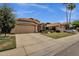 Charming home with lush landscaping, terracotta tile roofing, and a two-car garage provides great curb appeal at 1558 W Maplewood St, Chandler, AZ 85286