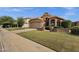 Charming home with a well-manicured lawn, attractive landscaping, and a stylish terracotta-tiled roof at 1558 W Maplewood St, Chandler, AZ 85286