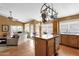 Bright open kitchen with island, dining table, tile floors, seamlessly flows into the living room at 1558 W Maplewood St, Chandler, AZ 85286