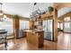 Modern kitchen featuring stainless steel appliances, island, and wooden cabinets, blending style and functionality at 1558 W Maplewood St, Chandler, AZ 85286
