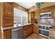 Well-lit kitchen with stainless steel appliances, ample cabinets, and granite countertops, creating a functional cooking space at 1558 W Maplewood St, Chandler, AZ 85286