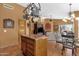 Open kitchen with an island, pendant lighting, and view to Gathering room, promoting a gathering space at 1558 W Maplewood St, Chandler, AZ 85286