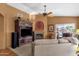 Spacious living room with fireplace, entertainment center, and view of the lake, offering a cozy atmosphere at 1558 W Maplewood St, Chandler, AZ 85286
