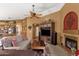 Relaxing living room with fireplace, entertainment unit, and tile floors, creating a cozy entertainment space at 1558 W Maplewood St, Chandler, AZ 85286
