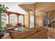 Bright living room features large windows, terracotta floors, neutral furniture, and a decorative screen at 1558 W Maplewood St, Chandler, AZ 85286