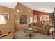 Sun-drenched living area showcases warm tones, terracotta tile floors, and comfortable seating for guests at 1558 W Maplewood St, Chandler, AZ 85286
