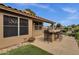 Back patio with an outdoor kitchen, bar seating, and views of a serene pond at 1558 W Maplewood St, Chandler, AZ 85286