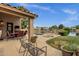 Covered patio with outdoor dining area and lounge chairs with tranquil waterfront views at 1558 W Maplewood St, Chandler, AZ 85286