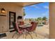 Covered patio with an outdoor dining set and pond views offers the perfect spot to unwind at 1558 W Maplewood St, Chandler, AZ 85286