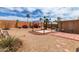 Desert landscaped backyard with gravel, brick accents, flowering plants and large gazebo at 15980 W Smokey Dr, Surprise, AZ 85374