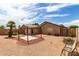 Scenic backyard showing gravel ground cover, patio, and gazebo and mature landscaping at 15980 W Smokey Dr, Surprise, AZ 85374