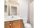 The bathroom has a white sink and toilet and a shower and vanity with cabinets at 15980 W Smokey Dr, Surprise, AZ 85374