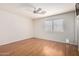Spacious bedroom with laminate floors, white walls, and a ceiling fan at 15980 W Smokey Dr, Surprise, AZ 85374