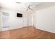 Bedroom has laminate floors, a ceiling fan, and access to the bathroom at 15980 W Smokey Dr, Surprise, AZ 85374