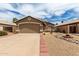 Cozy single-story home featuring a two-car garage and drought-resistant landscaping at 15980 W Smokey Dr, Surprise, AZ 85374