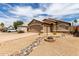 Charming single-story home with low-maintenance desert landscaping and rock feature at 15980 W Smokey Dr, Surprise, AZ 85374