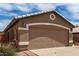 Close-up shot of the two-car garage with desert-style landscaping and accents at 15980 W Smokey Dr, Surprise, AZ 85374