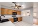 Kitchen with oak cabinets, white countertops, black appliances, and a passthrough at 15980 W Smokey Dr, Surprise, AZ 85374