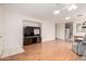 Well-lit living area featuring hardwood floors, a ceiling fan, and a modern television at 15980 W Smokey Dr, Surprise, AZ 85374
