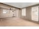 Spacious living room with multiple windows and doors leading to outdoor spaces at 15980 W Smokey Dr, Surprise, AZ 85374