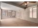 Bright sunroom with abundant windows, neutral carpet, and mini split air conditioning unit at 15980 W Smokey Dr, Surprise, AZ 85374