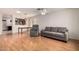 Open-concept living area with hardwood flooring, neutral walls, and a cozy seating area at 15980 W Smokey Dr, Surprise, AZ 85374