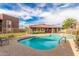 Inviting community pool area with ample seating and a clubhouse for residents' enjoyment at 16602 N 25Th St # 204, Phoenix, AZ 85032